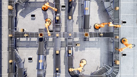 Robotic arms and conveyor belts sorting and moving boxes in an automated warehouse.